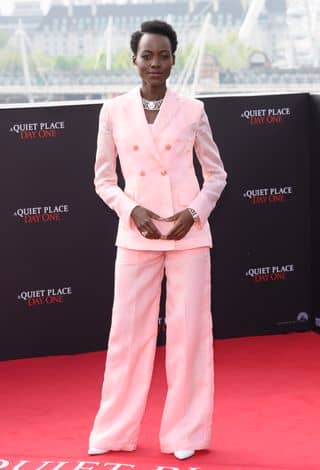 Lupita Nyong’o wears a bubblegum pink tailored set during a photo call for 'A Quiet Place: Day One'